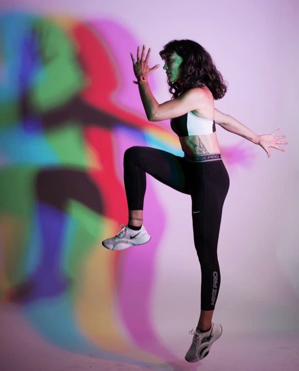 Ecem Onaran performing an athletic jump in studio lighting